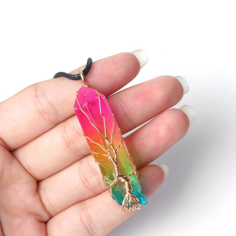 Wire-wrapped natural white quartz crystal point "Tree of Life" pendant with an iridescent electroplated finish.