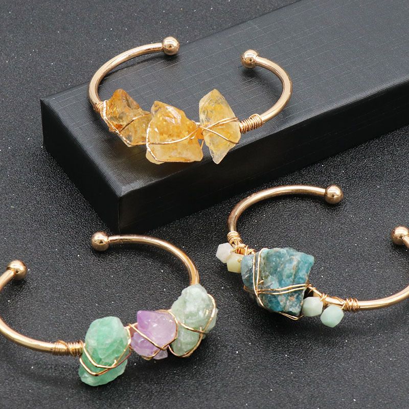 Open-cuff wire-wrapped bracelet featuring natural amethyst and citrine raw stones.