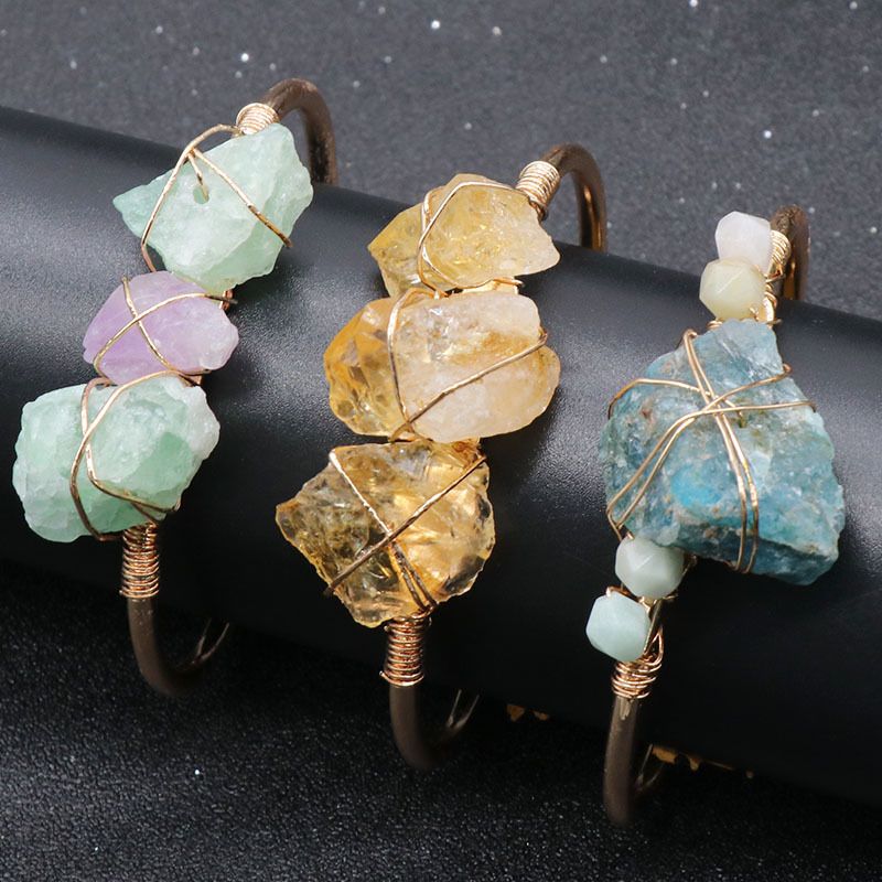 Open-cuff wire-wrapped bracelet featuring natural amethyst and citrine raw stones.