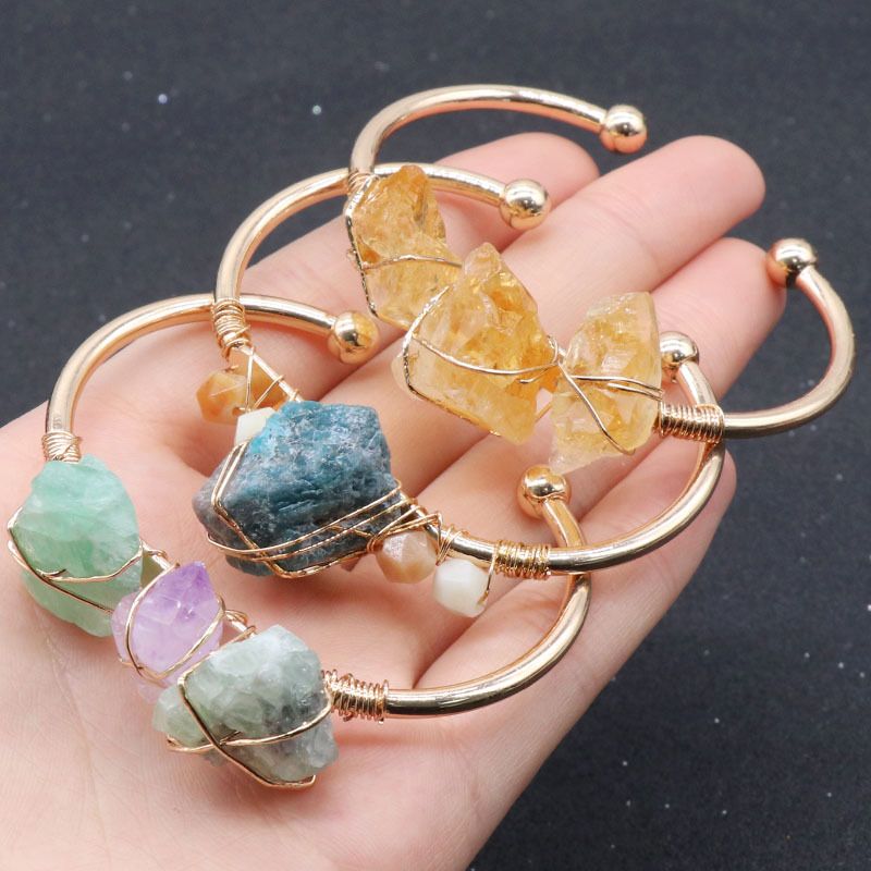 Open-cuff wire-wrapped bracelet featuring natural amethyst and citrine raw stones.