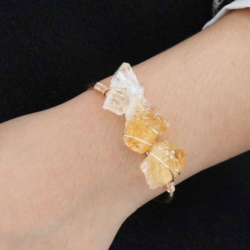 Open-cuff wire-wrapped bracelet featuring natural amethyst and citrine raw stones.