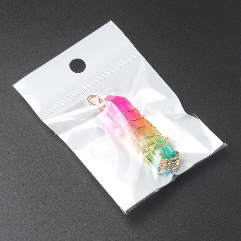 Wire-wrapped natural white quartz crystal point "Tree of Life" pendant with an iridescent electroplated finish.